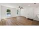 Bright living room with wood floors, natural light and a modern ceiling fan and front door at 10113 Huntley St, New Port Richey, FL 34654