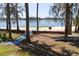 Moon Lake Park features a sandy beach, picnic tables, mature trees, and a scenic view of the water at 10113 Huntley St, New Port Richey, FL 34654