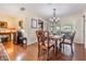 Charming dining room featuring hardwood floors, chandelier, and bright windows at 11528 Country Oaks Dr, Tampa, FL 33618