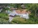 Charming single-Gathering home with a pool and a covered parking area surrounded by lush greenery and mature trees at 11718 N Ola Ave, Tampa, FL 33612