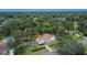 Drone view of the property featuring mature trees and a backyard pool at 11718 N Ola Ave, Tampa, FL 33612
