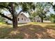 Large backyard surrounded by mature trees offering shade and privacy to the home at 11718 N Ola Ave, Tampa, FL 33612