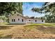 View of the back of this charming home, showcasing its well-maintained backyard at 11718 N Ola Ave, Tampa, FL 33612