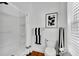 Well-lit bathroom with shower and decorative art at 11718 N Ola Ave, Tampa, FL 33612