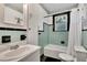 Vintage bathroom featuring blue tile, classic fixtures, and a framed Eiffel Tower print at 11718 N Ola Ave, Tampa, FL 33612