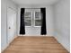 A bedroom with wood-look flooring and black-out curtains at 11718 N Ola Ave, Tampa, FL 33612