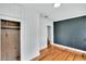 Bedroom with hardwood floors and wood paneled closet at 11718 N Ola Ave, Tampa, FL 33612