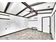 View of the bedroom showcasing a vaulted ceiling with beams, white wall paneling, and a ceiling fan at 11718 N Ola Ave, Tampa, FL 33612