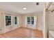 Bright bedroom with light wood-look floors and three windows offering ample natural light at 11718 N Ola Ave, Tampa, FL 33612