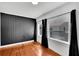 A bedroom with hardwood floors and black-out curtains at 11718 N Ola Ave, Tampa, FL 33612