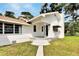 Charming single-story home with a white exterior, and a front porch at 11718 N Ola Ave, Tampa, FL 33612