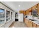 Cozy kitchen featuring wood cabinets, and white countertops at 11718 N Ola Ave, Tampa, FL 33612