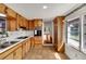 Traditional kitchen with wooden cabinetry, tile backsplash, and stainless steel sink at 11718 N Ola Ave, Tampa, FL 33612