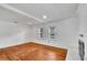 Spacious living room featuring hardwood floors, white walls, and a brick fireplace at 11718 N Ola Ave, Tampa, FL 33612