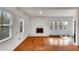 Bright living room featuring hardwood floors, white brick fireplace, and lots of natural light at 11718 N Ola Ave, Tampa, FL 33612