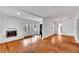 Open living room with fireplace, hardwood floors, and lots of natural light at 11718 N Ola Ave, Tampa, FL 33612