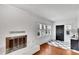 Bright living room featuring a fireplace, hardwood floors, and ample natural light at 11718 N Ola Ave, Tampa, FL 33612