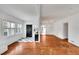 Inviting living room with hardwood floors, fireplace, and stylish black and white checkered entryway at 11718 N Ola Ave, Tampa, FL 33612