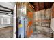 Utility room featuring a water heater and unfinished walls at 11718 N Ola Ave, Tampa, FL 33612