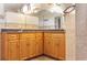 Close up on the granite countertop and cabinetry in this well lit and modern bathroom at 130 80Th Ne Ave, St Petersburg, FL 33702