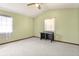 This olive-walled bedroom features neutral carpet, a ceiling fan, and a built-in desk at 130 80Th Ne Ave, St Petersburg, FL 33702