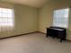 Carpeted bedroom with a desk and two windows that provide natural light at 130 80Th Ne Ave, St Petersburg, FL 33702