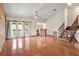 Spacious living room boasts hardwood floors, glass patio doors, and staircase at 130 80Th Ne Ave, St Petersburg, FL 33702