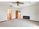 Bright main bedroom features neutral carpet, a fireplace, and two doorways, adding to its spaciousness and functionality at 130 80Th Ne Ave, St Petersburg, FL 33702