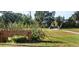 Rio Vista Park entrance features a wooden sign, lush greenery, and a glimpse of a footbridge in the distance at 130 80Th Ne Ave, St Petersburg, FL 33702