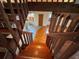 View of a wooden staircase leading to a bright living space with hardwood floors and large windows at 130 80Th Ne Ave, St Petersburg, FL 33702