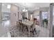 Dining room with a decorative rug, modern light fixture, and windows with patterned curtains at 13012 Creek Manor Ct, Riverview, FL 33569