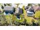 Aerial view of a home with a backyard pool, grassy yard, and a white fence in a suburban neighborhood at 1307 Garden Stone Ln, Brandon, FL 33510
