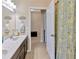 Inviting bathroom features double vanity, framed mirror, and patterned shower curtain for a modern touch at 1307 Garden Stone Ln, Brandon, FL 33510