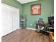 This bedroom features wood floors, a desk area, and a closet for storage at 1307 Garden Stone Ln, Brandon, FL 33510