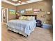 Cozy bedroom featuring a comfortable king-sized bed with decorative pillows and wood flooring at 1307 Garden Stone Ln, Brandon, FL 33510