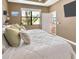Bedroom features a queen size bed, large window, and neutral walls with an adjoining bathroom at 1307 Garden Stone Ln, Brandon, FL 33510