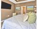 Spacious bedroom featuring a large bed, mounted TV, and comfortable decor at 1307 Garden Stone Ln, Brandon, FL 33510