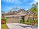 Charming home with a two-car garage, well-maintained landscaping, and inviting front entrance at 1307 Garden Stone Ln, Brandon, FL 33510