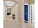 Light-filled hallway with neutral tile flooring, leading to arched doorways and offering a glimpse into the living space at 1307 Garden Stone Ln, Brandon, FL 33510