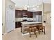 This kitchen features dark cabinets, stainless steel appliances, and an eat-in island at 1307 Garden Stone Ln, Brandon, FL 33510