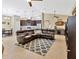 An open floorplan integrates the kitchen, dining, and living areas, enhanced by a large leather sectional and stylish decor at 1307 Garden Stone Ln, Brandon, FL 33510