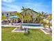 Backyard with a serene pool, lush tropical plants, and stone accents perfect for relaxation and entertainment at 1307 Garden Stone Ln, Brandon, FL 33510