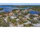 Aerial view of a home nestled in a lush neighborhood, with the ocean in the distance at 1426 75Th Ne Cir, St Petersburg, FL 33702