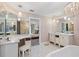 Elegant bathroom with double vanity, chandelier, and a view into the bedroom at 1426 75Th Ne Cir, St Petersburg, FL 33702