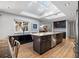 Bright kitchen with skylights, dark cabinetry, and island with seating at 1426 75Th Ne Cir, St Petersburg, FL 33702