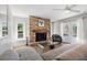 Cozy living room area features a stone fireplace and access to the outdoor pool at 1426 75Th Ne Cir, St Petersburg, FL 33702
