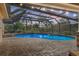 Stunning screened pool with brick pavers, set against a beautiful sunset sky with lush landscaping at 1426 75Th Ne Cir, St Petersburg, FL 33702