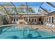Beautiful screened-in pool with a brick paved deck and plenty of space for entertaining and relaxation at 1426 75Th Ne Cir, St Petersburg, FL 33702
