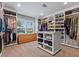 Spacious walk-in closet with custom shelving, drawers, and an island for ample storage and organization at 1426 75Th Ne Cir, St Petersburg, FL 33702