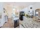 Kitchen with stainless steel appliances, a breakfast bar, and granite countertops and views into dining area at 1526 River Ct, Tarpon Springs, FL 34689